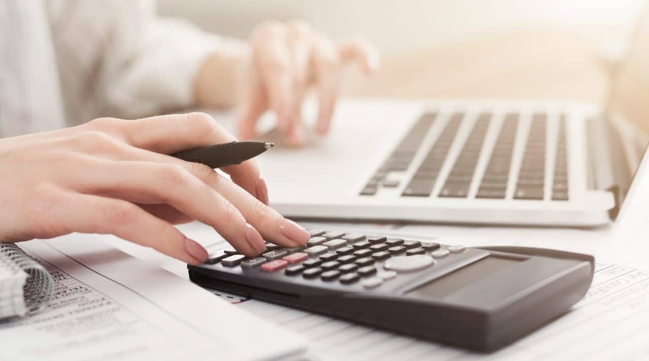 Auditing company. Business woman checking balance. Internal Revenue Service inspects document with laptop computer and calculator, copy space