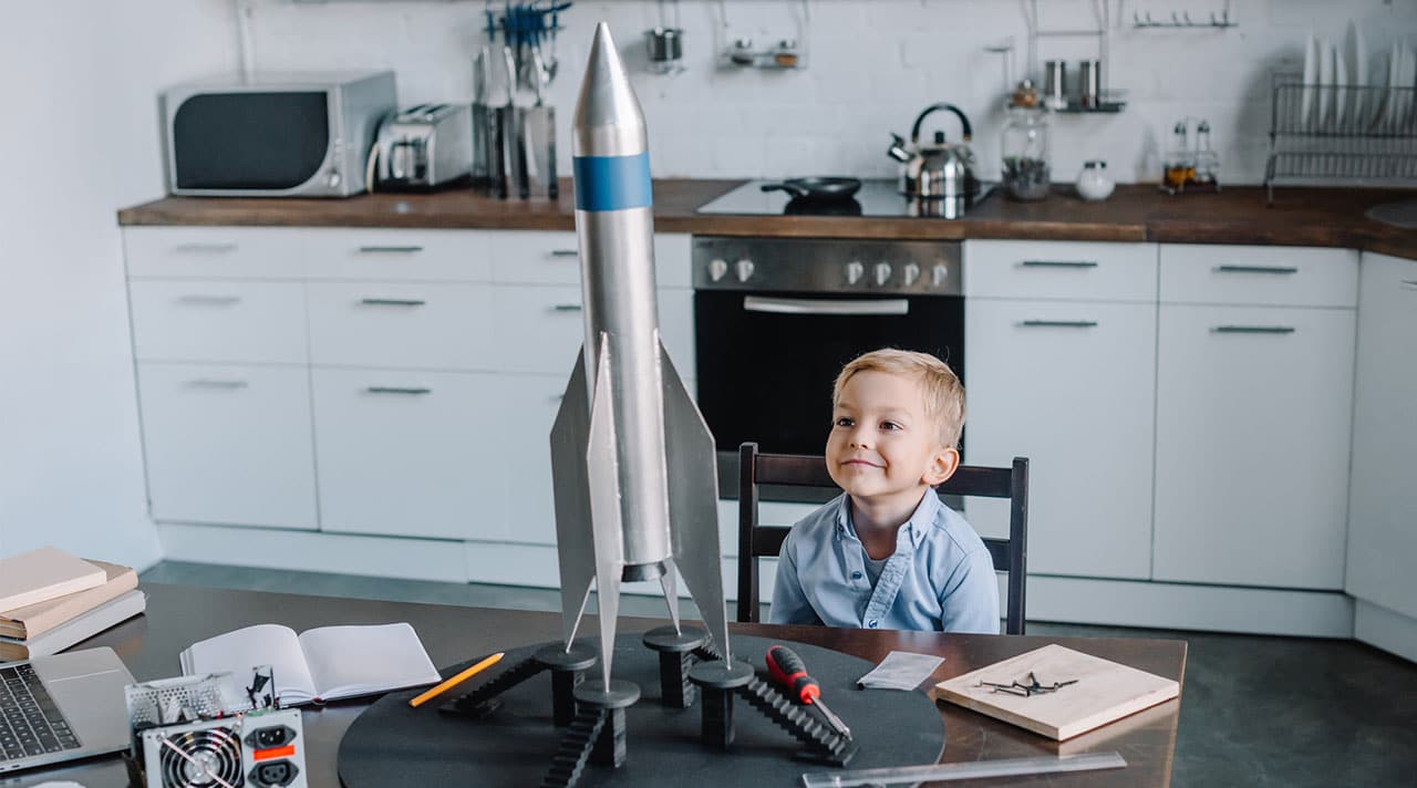 Young child building model rocket