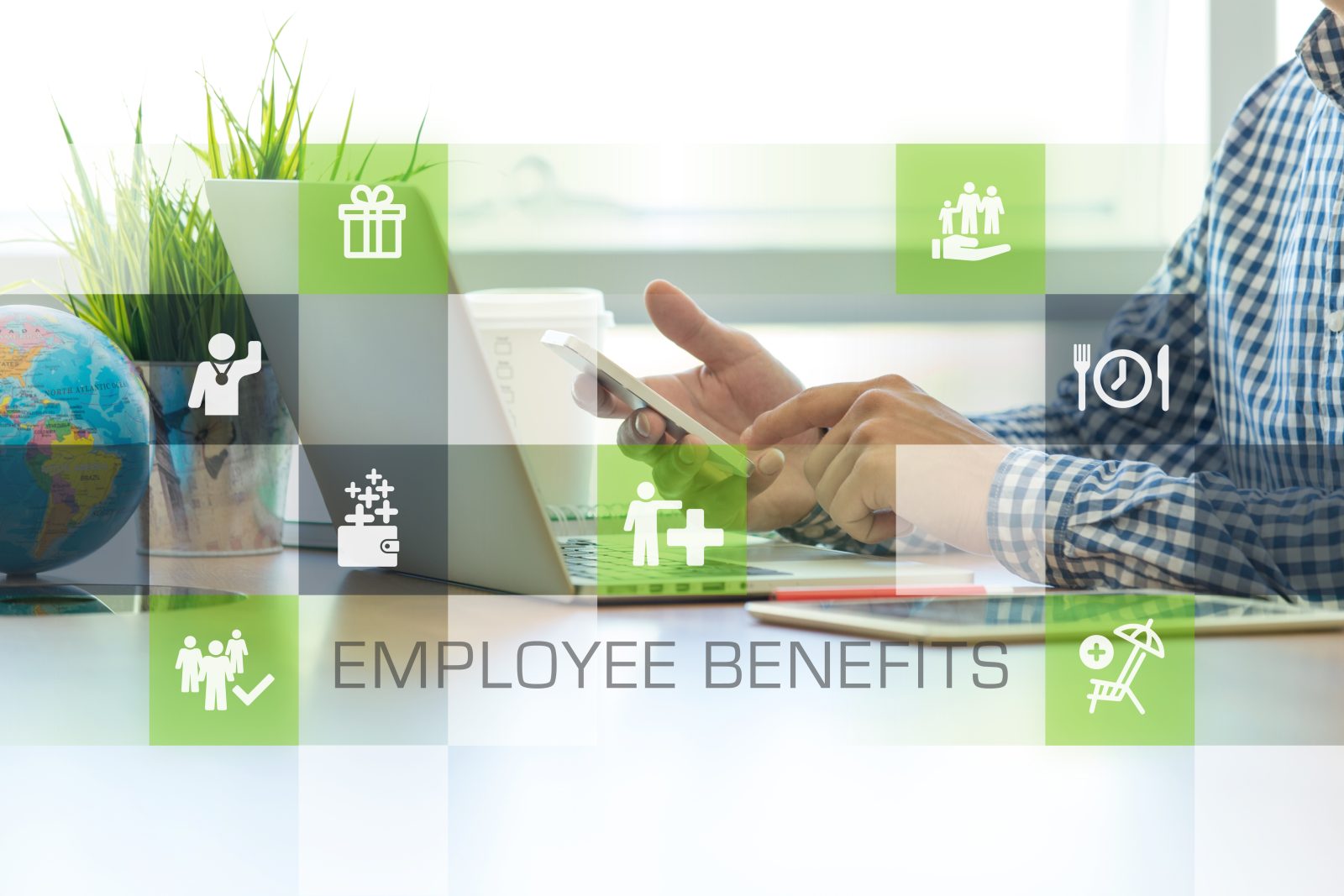 Man using phone and laptop researches employee benefits